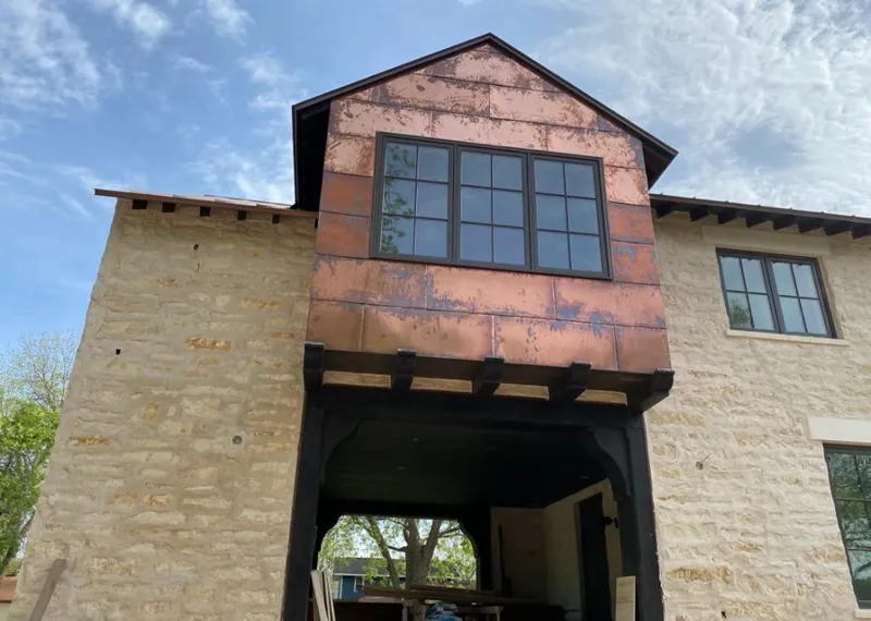Copper metal panel facade on a stone building for Skylight Installation in Laguna Woods