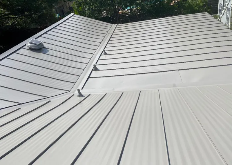 Solar attic fan installed on a metal roof for Roof Ventilation in Laguna Woods